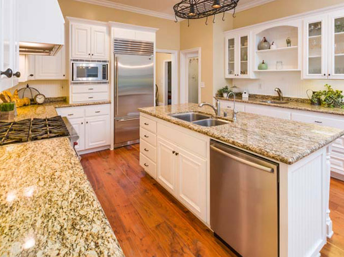 Kitchen with white cabinets and stone countertops