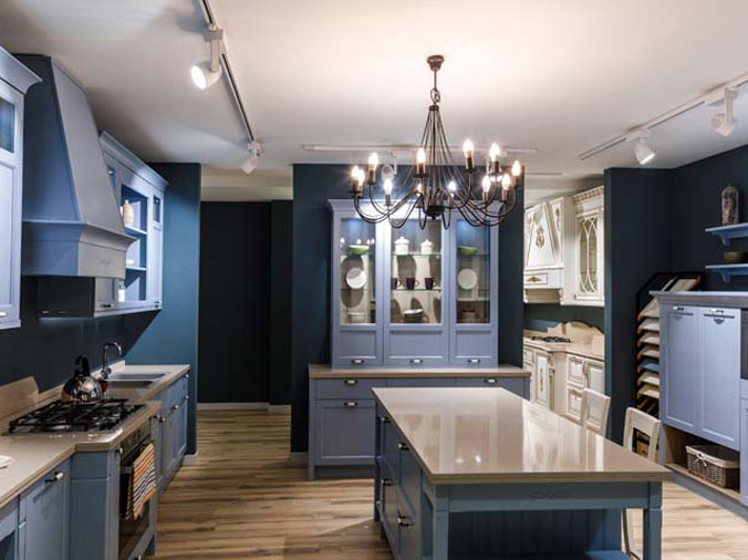 kitchen with island, blue walls and chandelier lighting
